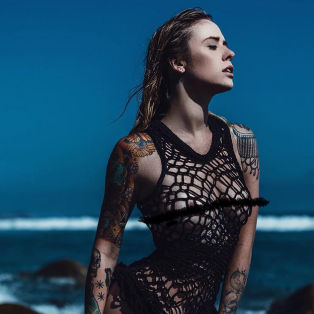 alysha nett, female model, woman on beach in front of coastline