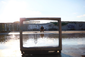 man posing in broken tv, photography