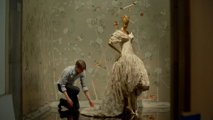 first monday in may, man working on a dress on a mannequin