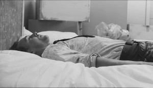 black and white photo of a man laying on the bed, Tom Hiddleston