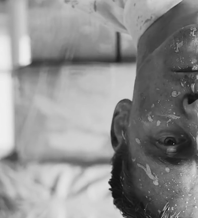 Tom Hiddleston upside down with paint on his face