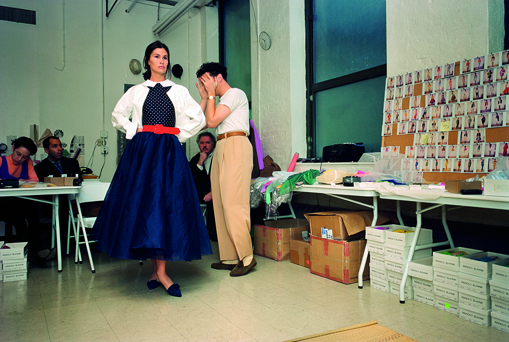 isaac mizrahi fashion, model backstage in blue dress during fitting
