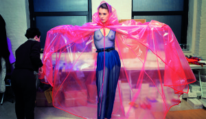 isaac mizrahi fashion, topless model with pink plastic poncho