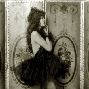 Ziegfeld girl posing with a dress