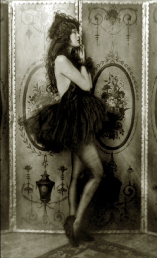 Ziegfeld girl posing with a dress