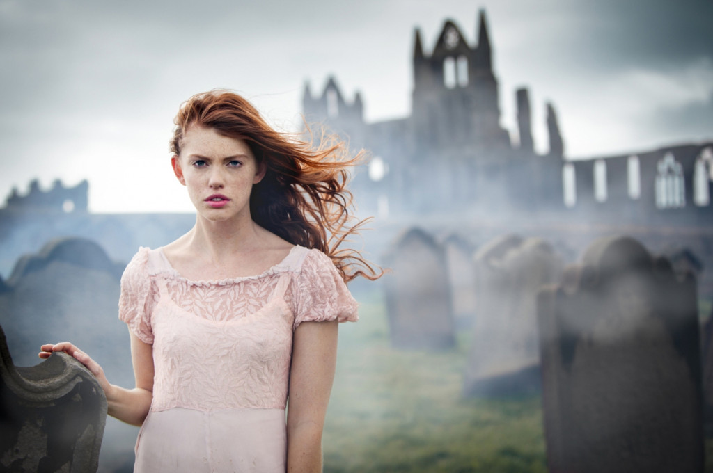 cade martin photography, red haired model standing in front of a foggy castle