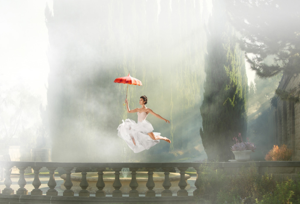 cade martin photography, woman jumping over balcony with umbrella