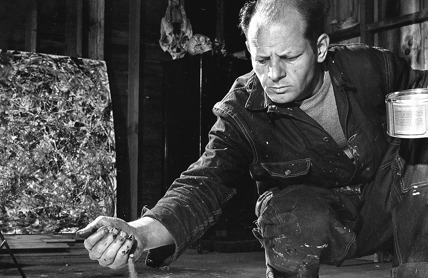 Artist Jackson Pollock dribbling sand on painting while working in his studio. (Photo by Martha Holmes/The LIFE Picture Collection/Getty Images)