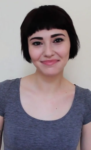 hi i am a slut, slam poetry, woman smiling with gray scoop neck shirt