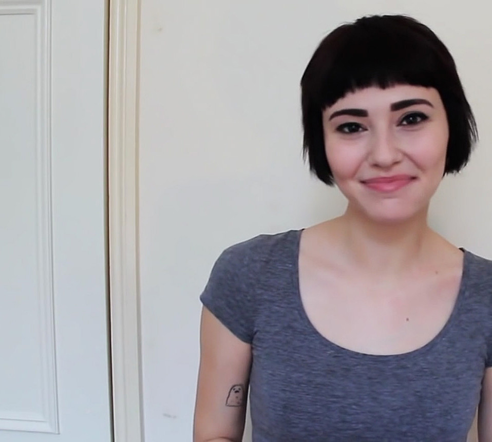 hi i am a slut, slam poetry, woman smiling with gray scoop neck shirt