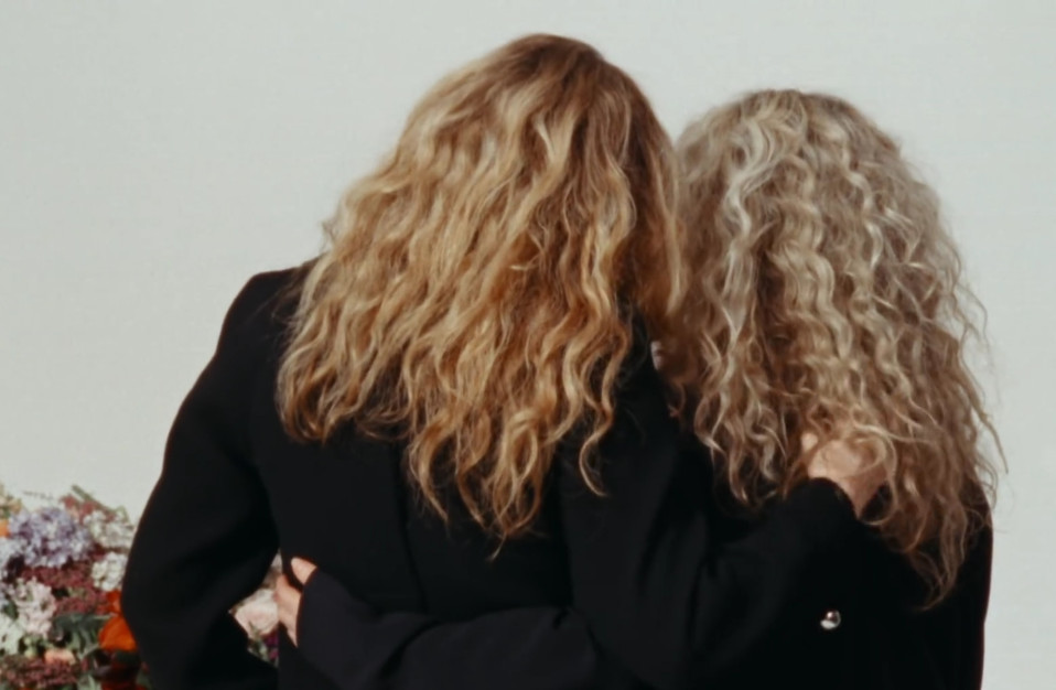Proenza Schouler's video, women with their backs to us and their arms around each other