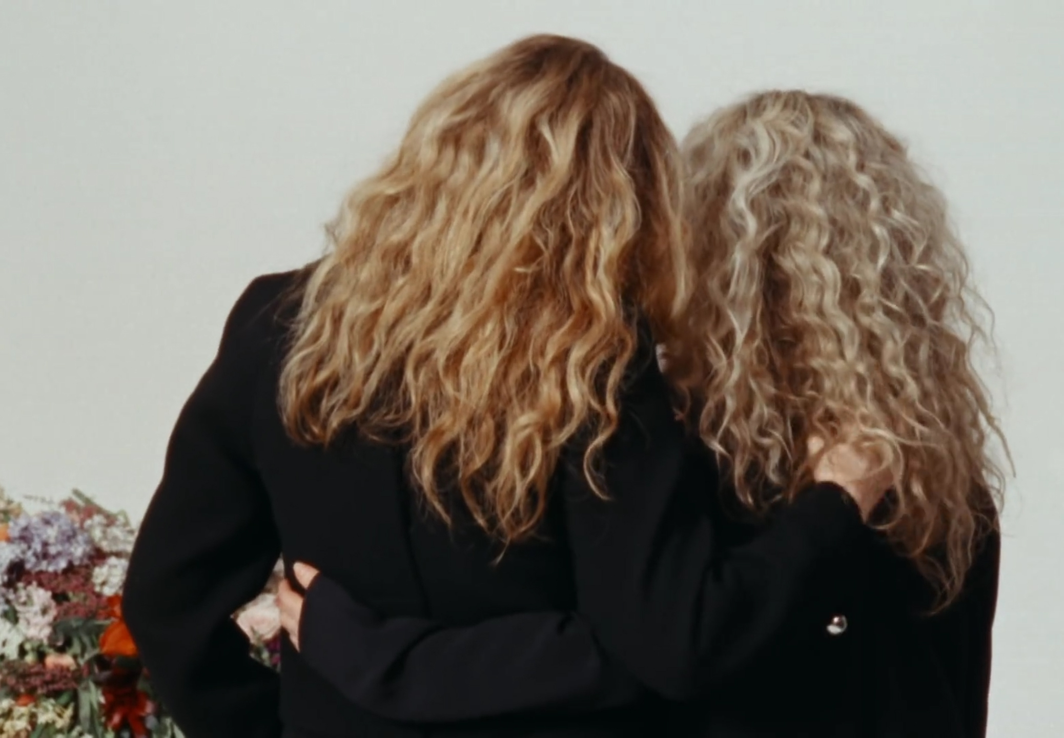 Proenza Schouler's video, women with their backs to us and their arms around each other