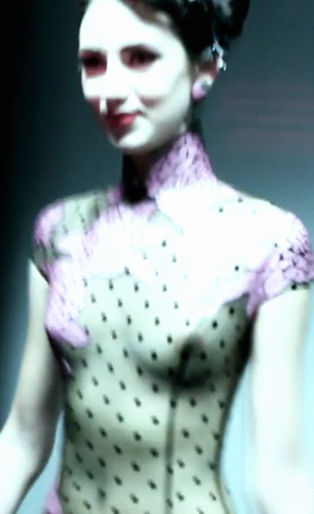 Atsuko Kudo's Lingerie London show, backstage shot of a model in latex corset with breasts exposed