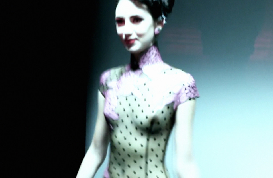 Atsuko Kudo's Lingerie London show, backstage shot of a model in latex corset with breasts exposed
