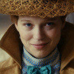 diary of a chambermaid movie, Jeanne Moreau wearing a beige hat and coat, with a blue bowtie