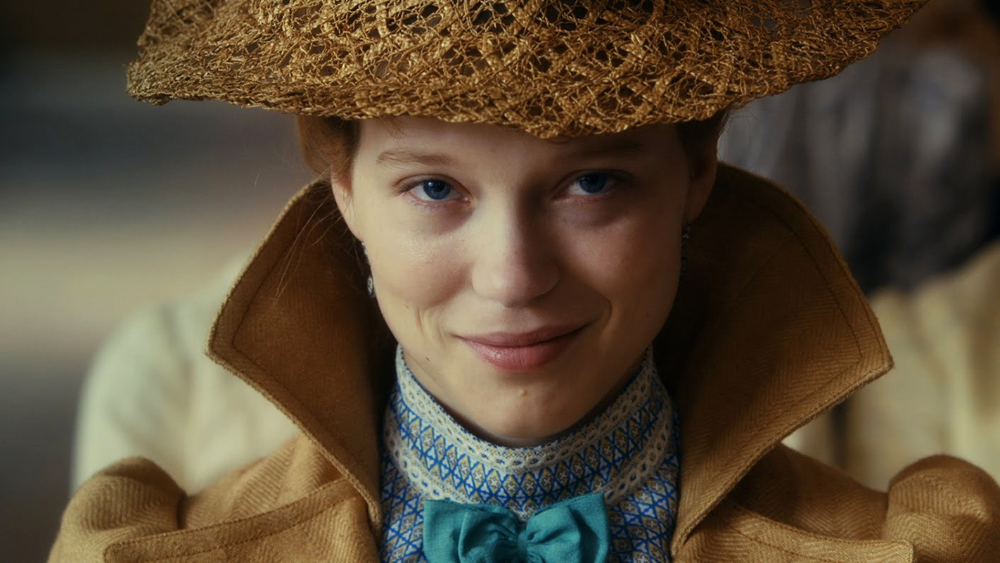 diary of a chambermaid movie, Jeanne Moreau wearing a beige hat and coat, with a blue bowtie