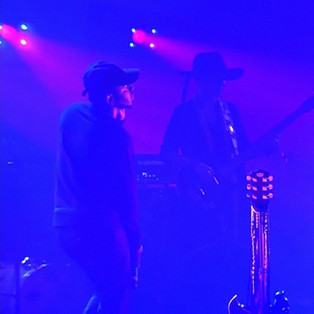 prince and kendrick lamar performing together on stage in purple lighting