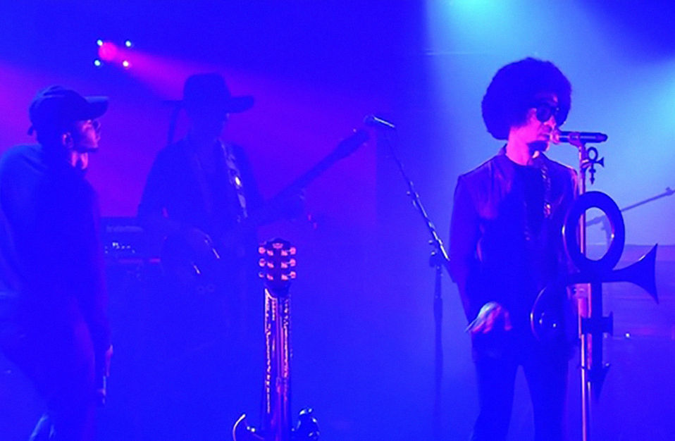 prince and kendrick lamar performing together on stage in purple lighting