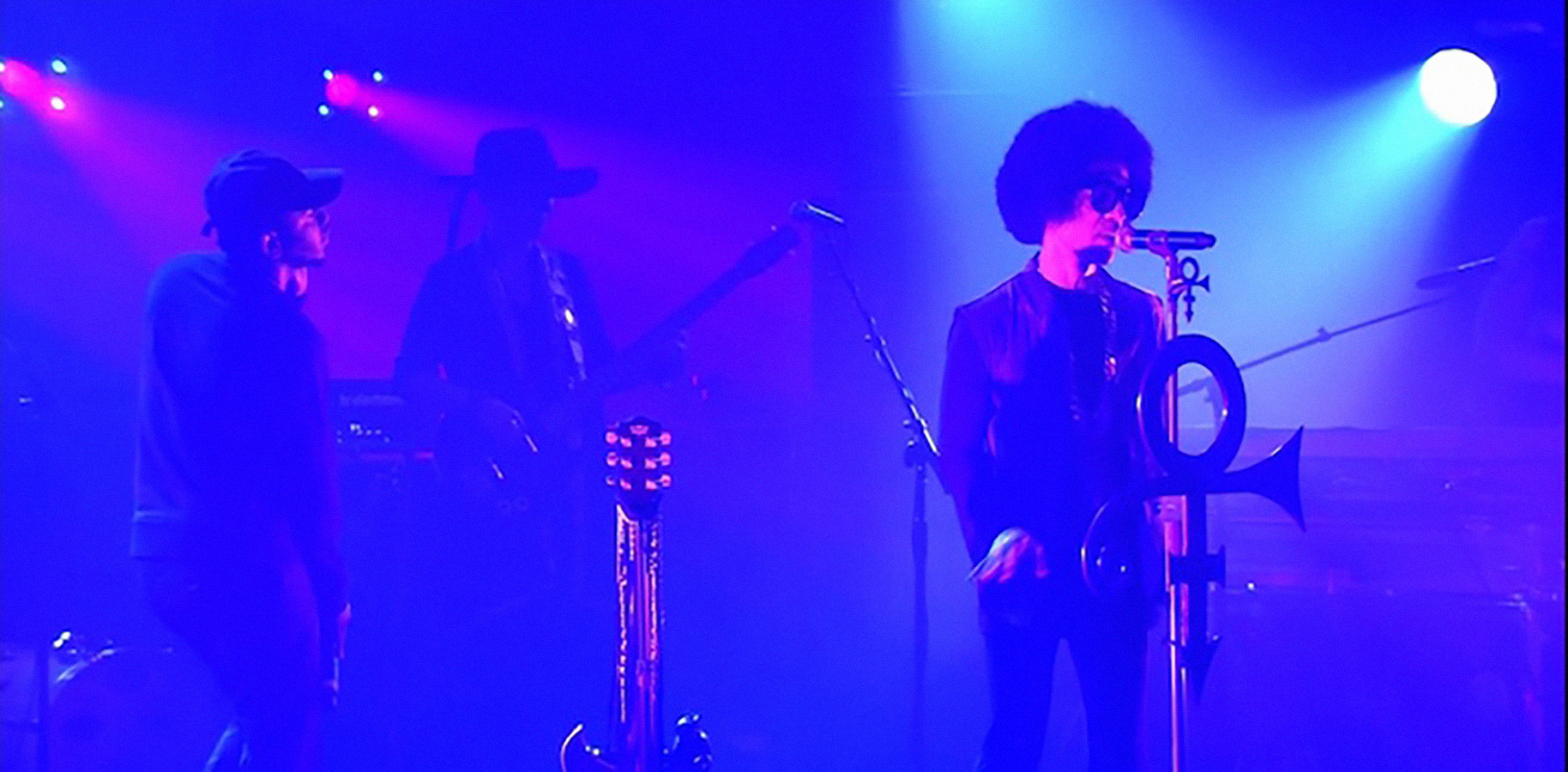 prince and kendrick lamar performing together on stage in purple lighting