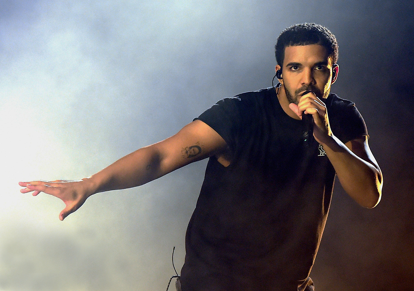 drake singing into a microphone
