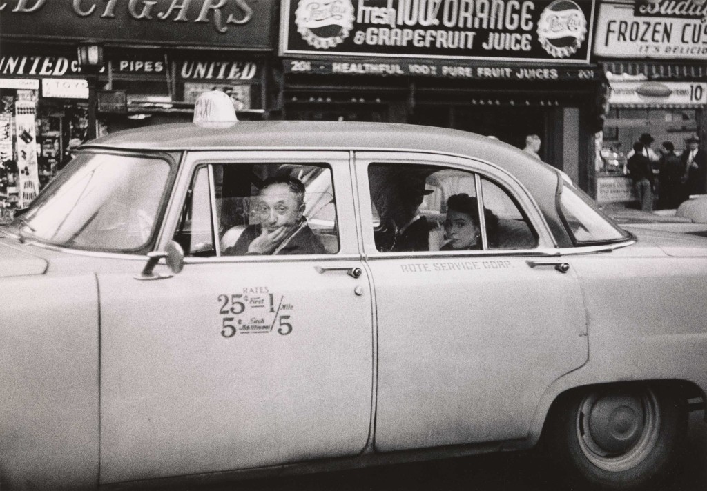 Diane Arbus. Taxicab driver at the wheel with two passengers, N.Y.C. 1956. ©The Estate of Diane Arbus, LLC. All Rights Reserved
