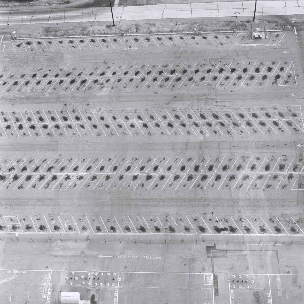 Lockheed Air Terminal, 2627 N. Hollywood Way, Burbank (1967), by Ed Ruscha, from the series Parking Lots (1999). Gelatin silver print, 20 x 16 inches. Published by Patrick Painter Editions, Vancouver and Hong Kong. Fine Arts Museums of San Francisco. © Ed Ruscha.