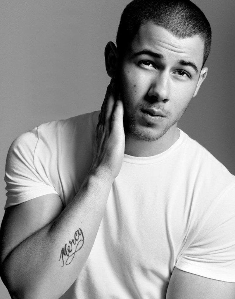 nick jonas wearing a classic white t-shirt