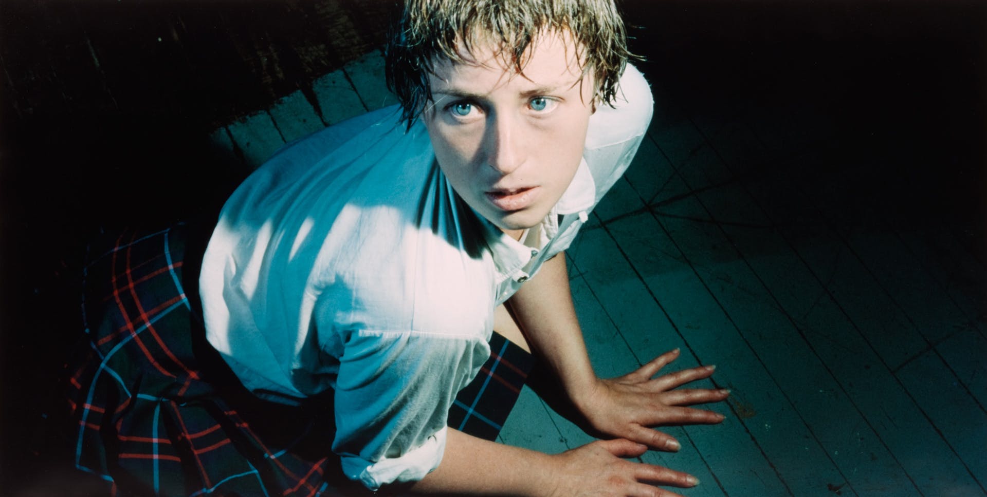 Cindy Sherman blue-eyed woman in blue shirt and plaid skirt