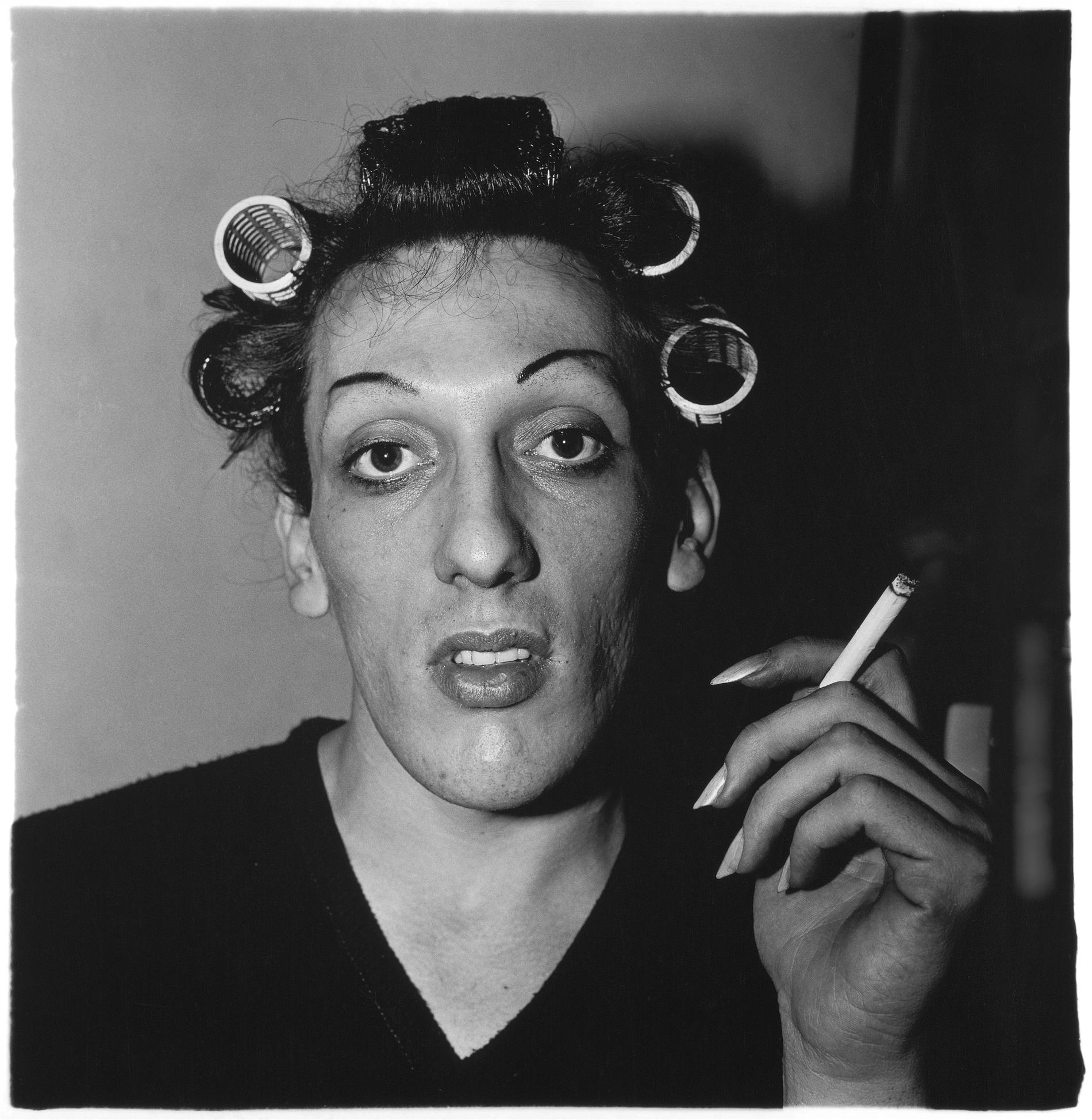 Diane Arbus woman in curlers smoking cigarette