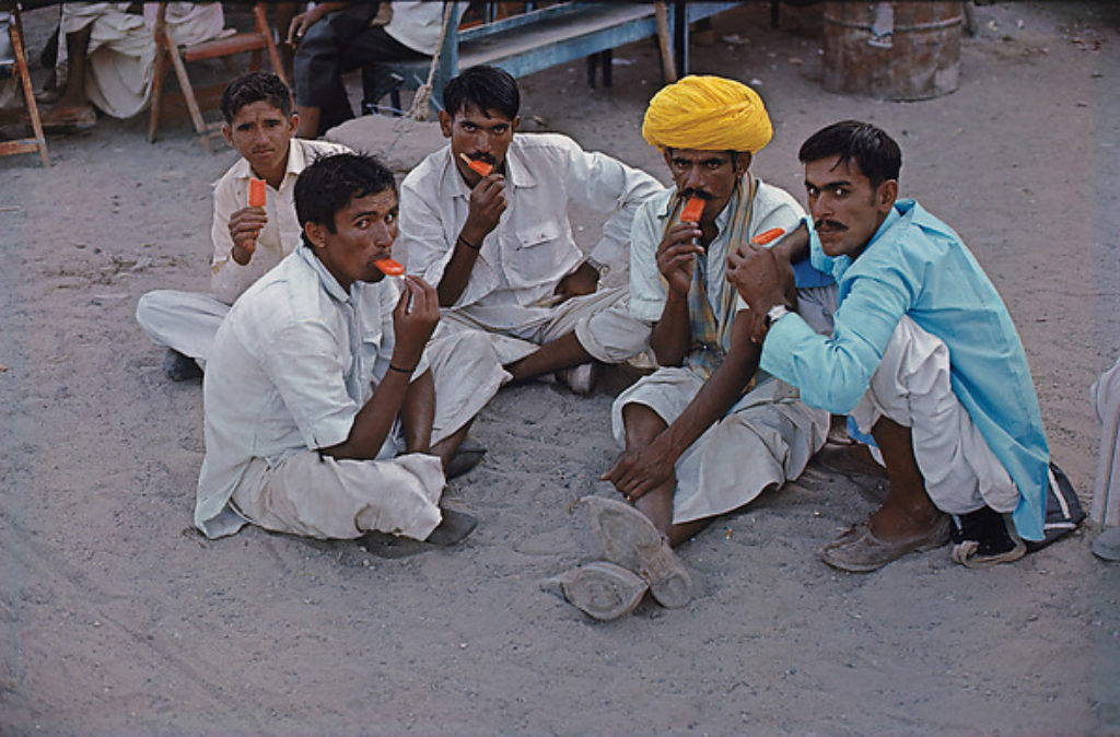 Indian photographer Raghubir photograph of local villagers enjoying red popsicles in Jodhpur India, 1978