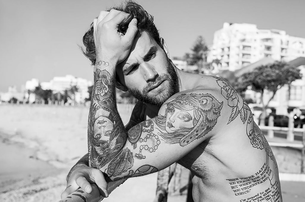 Photograph of Model Andre Hamman shirtless on the beach, June 2016