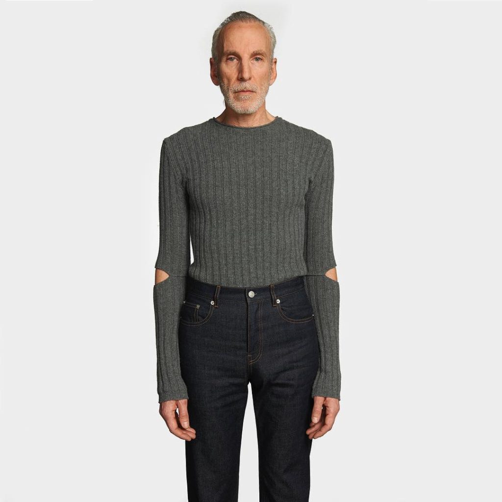 Helmut Lang older male model wearing jeans and a gray sweater