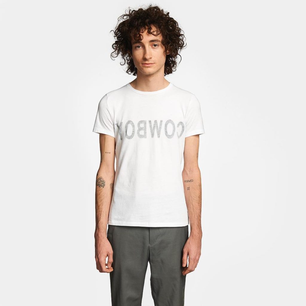 Helmut Lang Male Model with Curly Hair wearing a Cowboy t-shirt