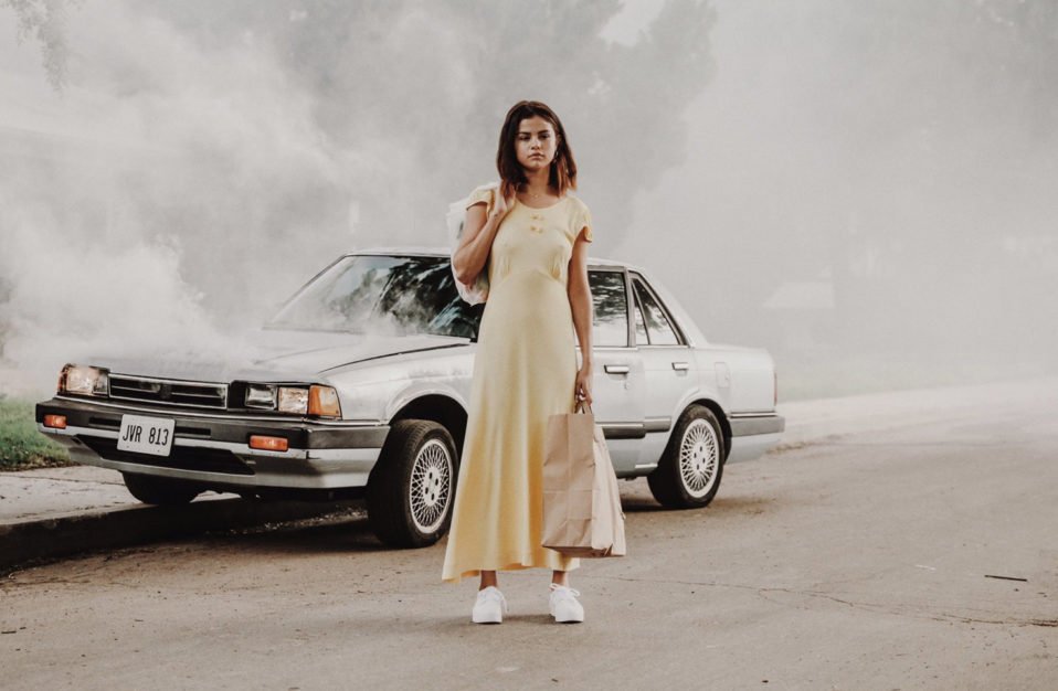 Petra Collins long yellow dress broken down car