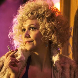 The Deuce Star Candy played by actress Maggie Gyllenhaal wearing one of her blonde afro wigs
