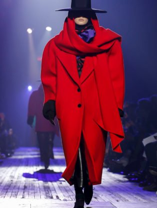 Photo of model in oversized red coat and flamenco black hat from Marc Jacobs Runway Show featuring Marc Jacob's Ready to Wear Collection for Fall/Winter 2018 in NYC