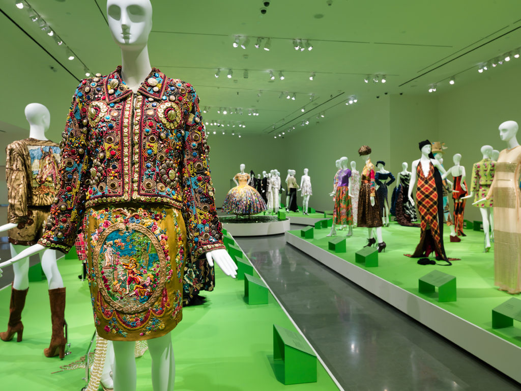 Photograph of a mannequin wearing an ornate skirt and brocade jacket at the Todd Oldham exhibition at the Wexner Center for the Arts