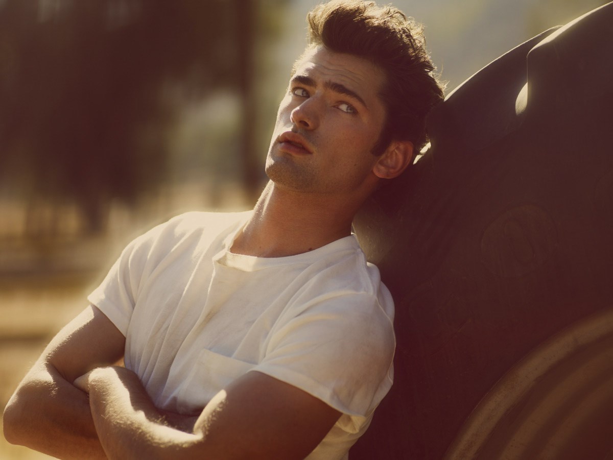 Sean O’Pry white t-shirt sitting against car