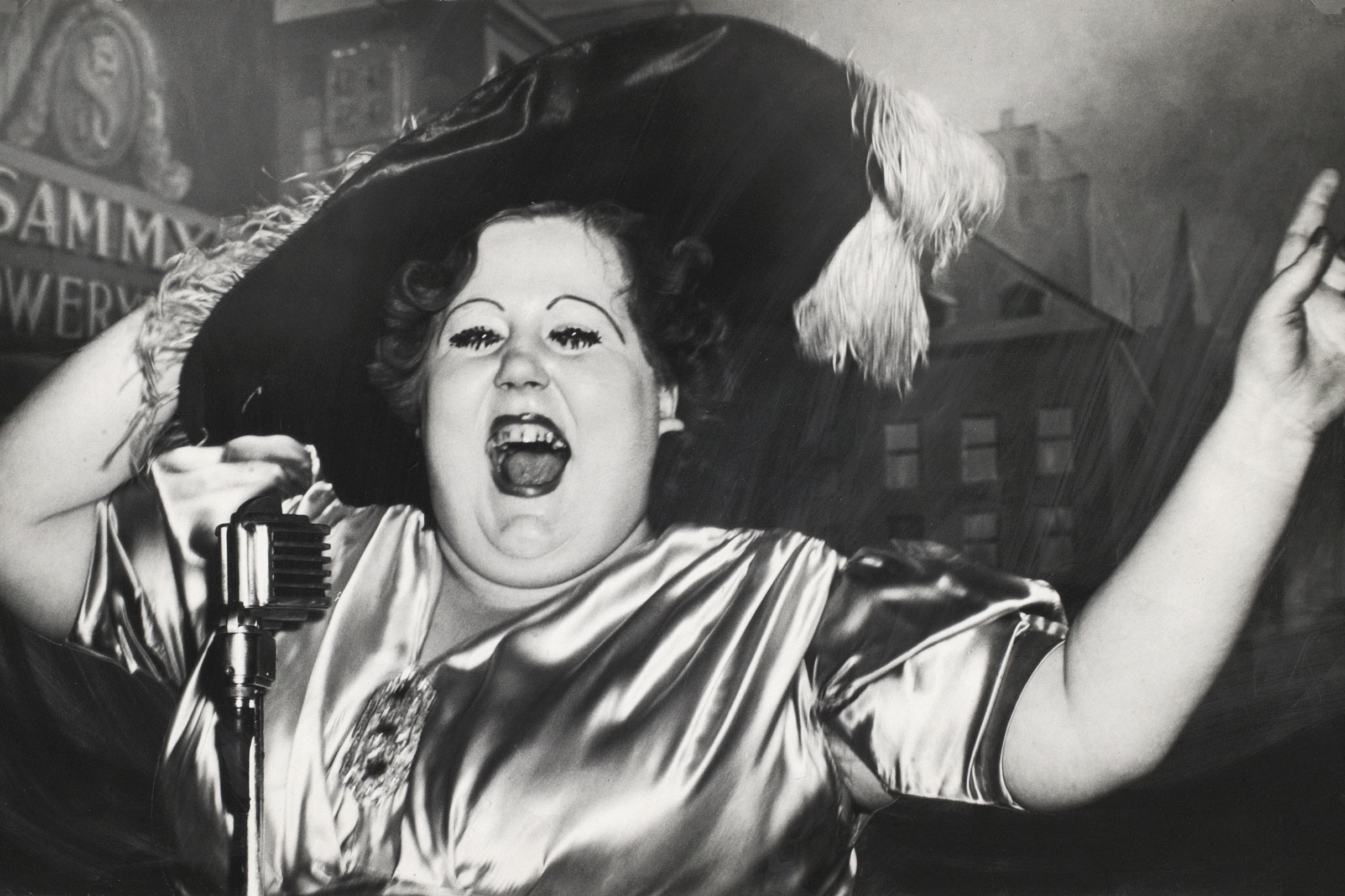 weegee - large lady in feather hat big smile