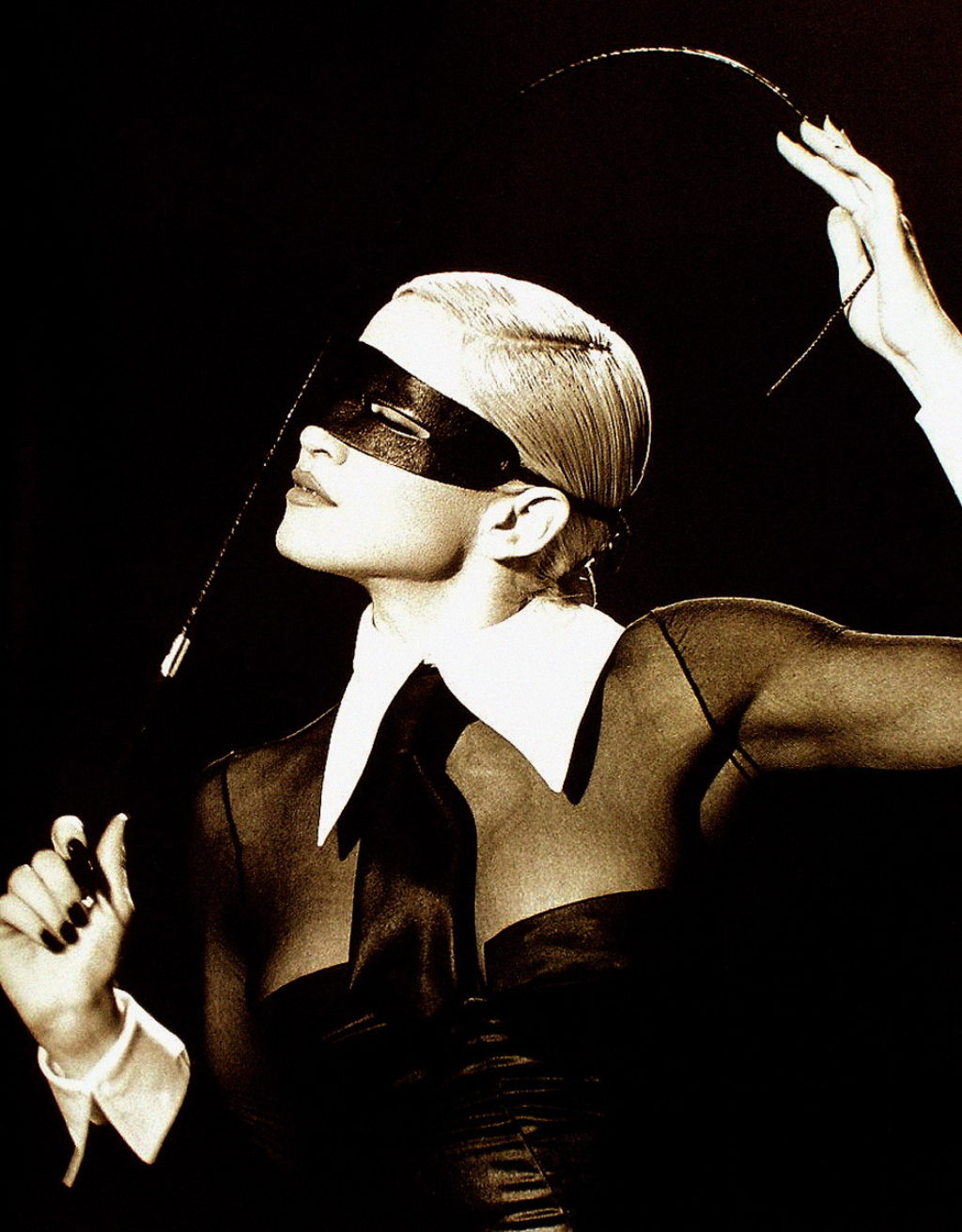 Madonna Erotica Wearing A Mask and Holding a Whip