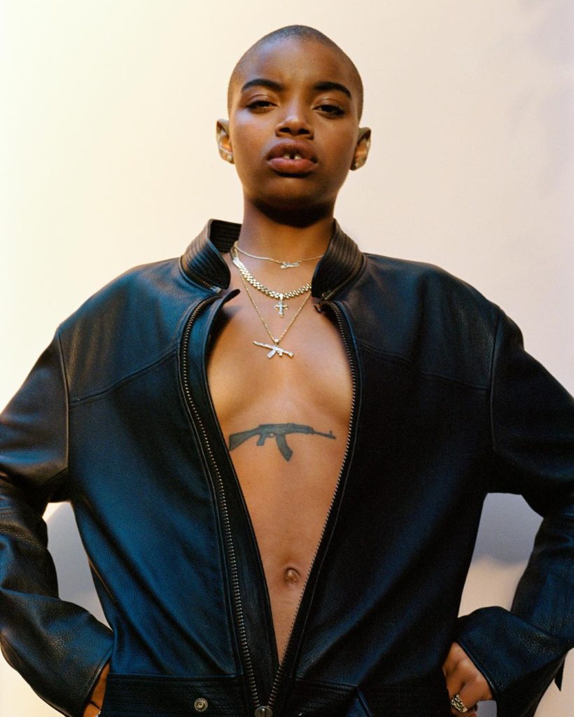 Tyler Mitchell photograph of a Female Model with Machine Gun Tattoo