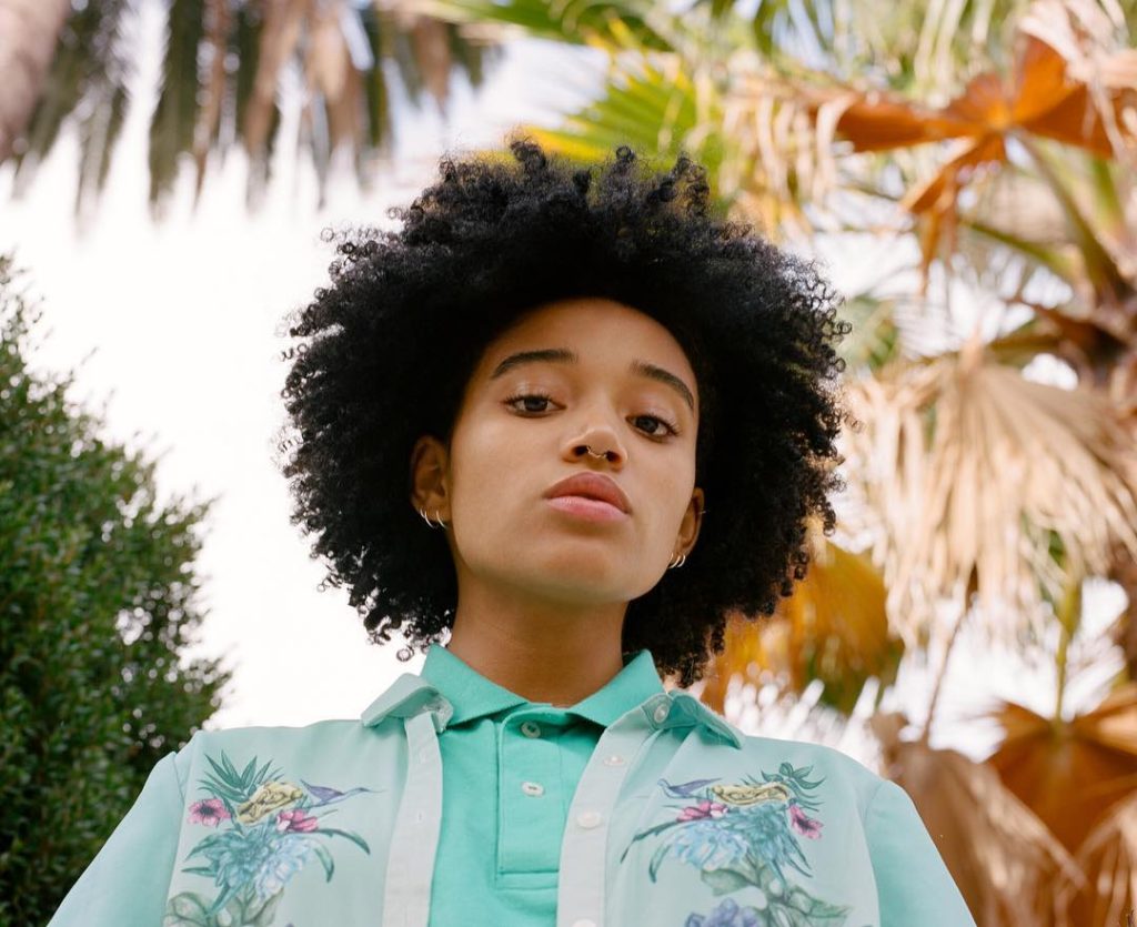Tyler Mitchell photograph of a Young Model wearing turquoise polo and floral shirt