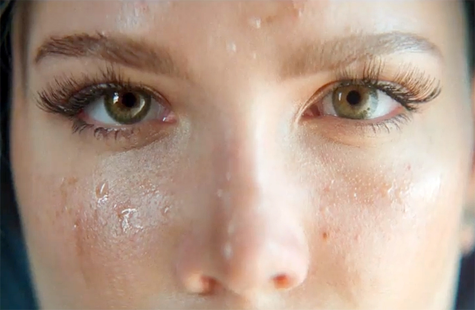 close up of Halsey showing her eyes and nose wth sweat on her cheeks