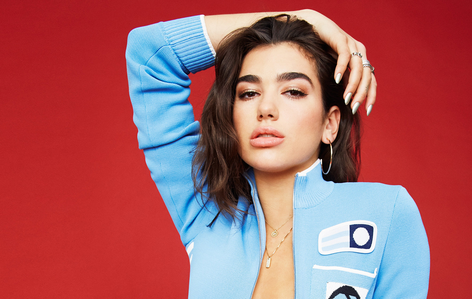 dua lipa blue open front sweater hand on head
