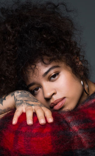 Ella Mai red plaid sitting