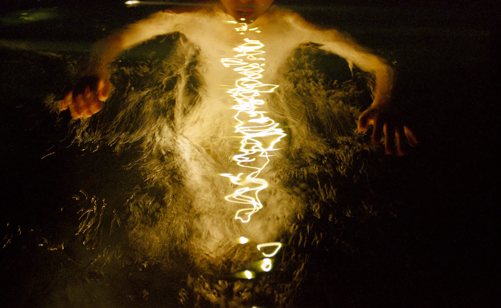 double exposure of a girl skinny dipping at night