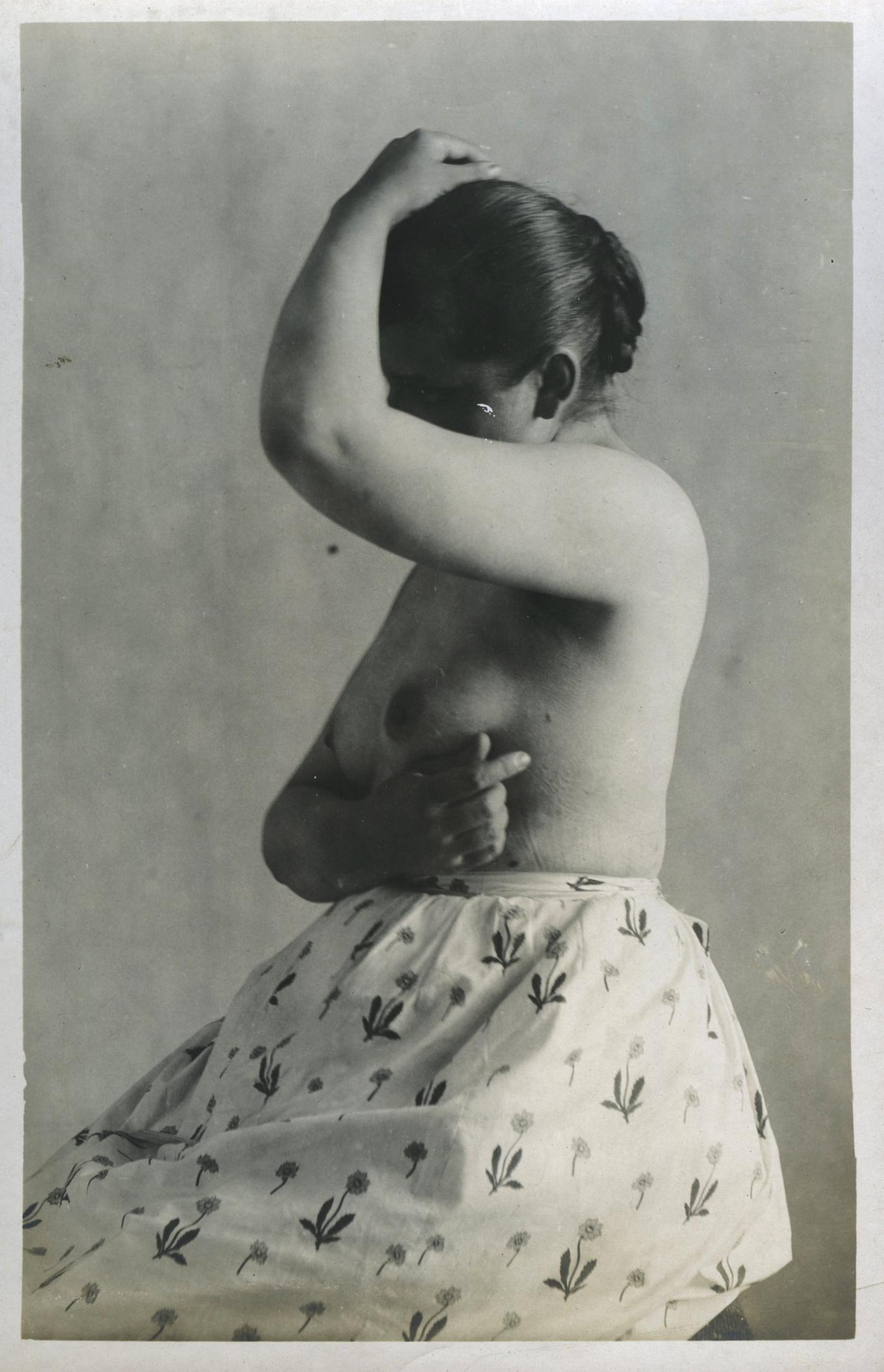 antique photograph of a topless woman in the 1890s