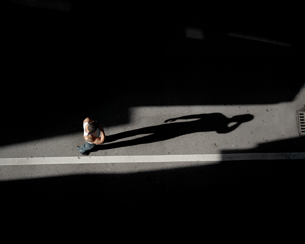 Clarissa Bonet, "Swelter" overhead shot of a pedestrian walking down the street