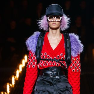 PRADA Men's 2019 Frankenstein Collection Runway Show in Milan Featuring Female Model with Lilac Hair, Lilac fur, White Sunglasses and White Patent Leather Boots