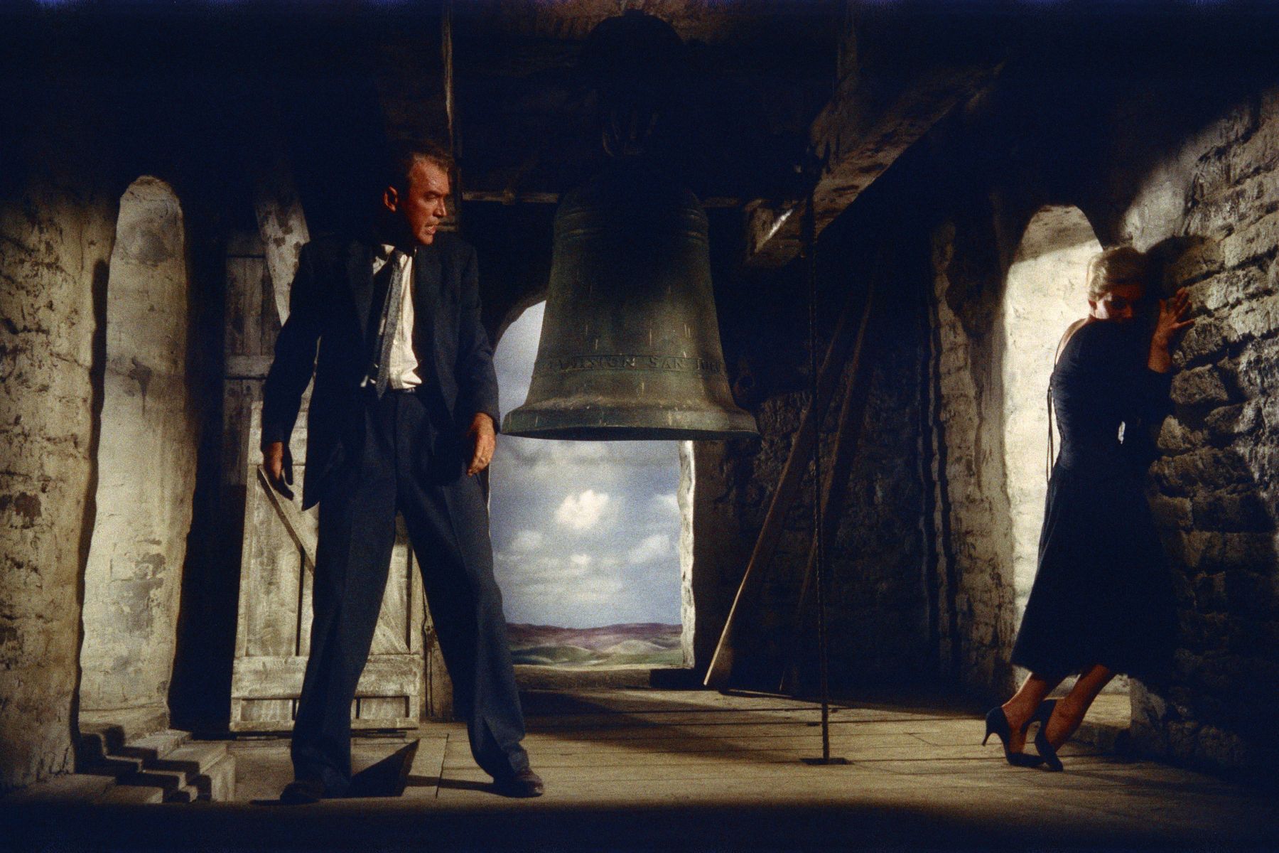 woman cowers before a threatening man in scene from "Vertigo" 1958